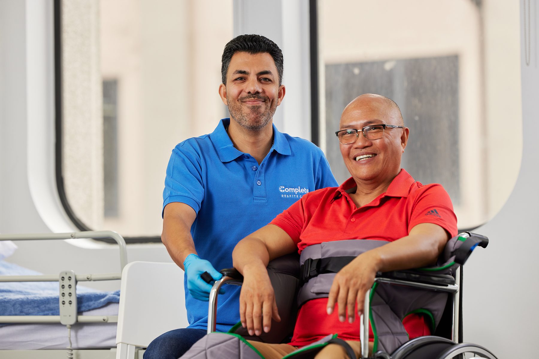 A support worker with his client, both smiling